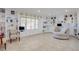 Spacious living room featuring built-in shelving, a large window, and neutral-colored furniture at 3431 Iberia St, Las Vegas, NV 89146