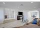 Bright living room with tile floors, brown sofa, and entertainment center, flowing into a dining area at 3431 Iberia St, Las Vegas, NV 89146