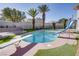 Backyard pool with diving board and slide surrounded by artificial turf, ideal for summer fun and lounging at 3431 Iberia St, Las Vegas, NV 89146