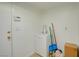 Small utility sink and cabinet with tile flooring and a white door at 3431 Iberia St, Las Vegas, NV 89146