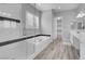 Modern bathroom featuring a glass shower, soaking tub, and double vanity with gray wood-look tile flooring at 351 Dandelion Brook Ct Ct, Las Vegas, NV 89148