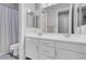 Bathroom with a double vanity, large mirrors, and gray wood-look tile flooring at 351 Dandelion Brook Ct Ct, Las Vegas, NV 89148