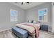 Bedroom with neutral decor, wood-look tile flooring, and a window with plantation shutters at 351 Dandelion Brook Ct Ct, Las Vegas, NV 89148
