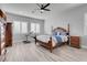 Bedroom with a king size bed, ceiling fan, and wood-style flooring at 351 Dandelion Brook Ct Ct, Las Vegas, NV 89148