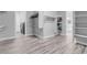 Walk-in closet with built-in shelving and gray wood-look tile flooring, adjacent to laundry room at 351 Dandelion Brook Ct Ct, Las Vegas, NV 89148