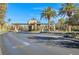 Street view of a community entrance with stone pillars, lush palm trees, and well-maintained landscaping at 351 Dandelion Brook Ct Ct, Las Vegas, NV 89148