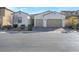 A single story home with three car garage and desert landscaping at 351 Dandelion Brook Ct Ct, Las Vegas, NV 89148