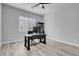 Home office with gray wood-look tile flooring, plantation shutters and black desk at 351 Dandelion Brook Ct Ct, Las Vegas, NV 89148