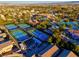 Aerial view of well-maintained tennis courts next to a large community pool, recreational area, and neighborhood homes at 351 Dandelion Brook Ct Ct, Las Vegas, NV 89148