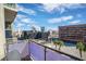 Balcony with views of the city skyline, palm trees, and surrounding buildings under a clear sky at 353 E Bonneville Ave # 752, Las Vegas, NV 89101