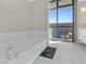 Soaking tub beside a large window with city views at 353 E Bonneville Ave # 752, Las Vegas, NV 89101