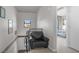 Hallway with chair and art leading to a bedroom with a bed, windows and modern decor at 353 E Bonneville Ave # 752, Las Vegas, NV 89101