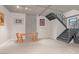 Open living space with a wooden table, modern lighting, and an industrial-style staircase at 353 E Bonneville Ave # 752, Las Vegas, NV 89101