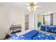 Comfortable bedroom with mirrored closet doors, fan, and neutral colored walls at 3866 Starfield Ln, Las Vegas, NV 89147