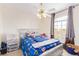 Cozy bedroom with a ceiling fan, large window, and a charming themed comforter at 3866 Starfield Ln, Las Vegas, NV 89147