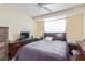 Bedroom with neutral walls, ceiling fan, and traditional wood furniture at 3866 Starfield Ln, Las Vegas, NV 89147