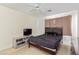 Cozy bedroom with a simple bed, dresser, and a TV stand, creating a functional and relaxing space at 3866 Starfield Ln, Las Vegas, NV 89147