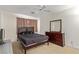 Bedroom featuring a queen-size bed, dresser, and a ceiling fan, creating a cozy and functional living space at 3866 Starfield Ln, Las Vegas, NV 89147
