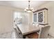 A bright dining room with a sliding glass door providing natural light, complemented by a stylish chandelier and spacious layout at 3866 Starfield Ln, Las Vegas, NV 89147