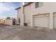 Beige stucco house with a white garage door with space for parking in front at 3866 Starfield Ln, Las Vegas, NV 89147
