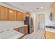 Functional kitchen featuring stainless steel appliances, ample cabinet space, and access to the laundry area for added convenience at 3866 Starfield Ln, Las Vegas, NV 89147