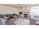 Living room featuring a fireplace, gray sofa, hardwood floors and an area rug at 3866 Starfield Ln, Las Vegas, NV 89147