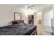 Spacious bedroom with neutral tones, a ceiling fan, dresser, and an en-suite bathroom, creating a comfortable and private retreat at 3866 Starfield Ln, Las Vegas, NV 89147