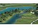 Aerial view of the community golf course featuring a pond, trees, and manicured green lawns at 4485 E Brusca Way, Pahrump, NV 89061