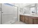 A modern bathroom features dual sinks, a glass-enclosed shower, and stylish fixtures at 4485 E Brusca Way, Pahrump, NV 89061