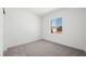 A bright, simple bedroom featuring neutral gray carpeting and a window overlooking the neighborhood at 4485 E Brusca Way, Pahrump, NV 89061