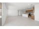 Bright and spacious living area open to the modern kitchen, featuring sleek white tile flooring and ample natural light at 4485 E Brusca Way, Pahrump, NV 89061