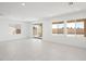 Spacious living room with bright white tile floors, lots of natural light from three large windows at 4485 E Brusca Way, Pahrump, NV 89061