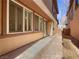 Backyard view featuring brick-paved patio with beige exterior, white trim windows, and desert landscaping at 7719 Windy Meadow Ave, Las Vegas, NV 89178
