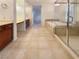 Luxurious bathroom featuring a soaking tub, glass enclosed shower, and dual vanities with tile floors at 7719 Windy Meadow Ave, Las Vegas, NV 89178