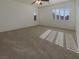 Bright bedroom featuring neutral walls, ample natural light, and neutral carpet at 7719 Windy Meadow Ave, Las Vegas, NV 89178
