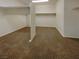 Open walk-in closet featuring neutral carpeting and shelving at 7719 Windy Meadow Ave, Las Vegas, NV 89178