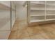 Spacious walk-in closet with ample shelving and neutral tile flooring at 7719 Windy Meadow Ave, Las Vegas, NV 89178