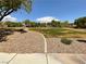 A sidewalk leads through a community park with grassy areas and trees at 7719 Windy Meadow Ave, Las Vegas, NV 89178