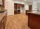 Modern kitchen boasting wood cabinets, granite countertops, stainless steel appliances, and wood flooring at 7719 Windy Meadow Ave, Las Vegas, NV 89178
