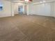 Spacious living room with neutral carpet, ceiling fan, and open archway to the rest of the home at 7719 Windy Meadow Ave, Las Vegas, NV 89178