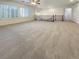 Spacious living room area with large windows and neutral carpeting at 7719 Windy Meadow Ave, Las Vegas, NV 89178