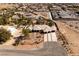 Aerial shot of a desert home with palm trees, lush landscaping, and a circular driveway at 8290 Gagnier Blvd, Las Vegas, NV 89113
