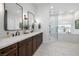Elegant bathroom with double sinks, a soaking tub, and a separate glass-enclosed shower, perfect for relaxation at 8290 Gagnier Blvd, Las Vegas, NV 89113