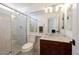 Bathroom featuring a large mirror, marble countertop, and a glass enclosed shower at 8290 Gagnier Blvd, Las Vegas, NV 89113