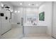 Modern bathroom featuring a large soaking tub, a glass-enclosed shower with bench, and stylish fixtures at 8290 Gagnier Blvd, Las Vegas, NV 89113