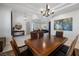 Elegant dining area featuring a wood table, chandelier, and open floor plan at 8290 Gagnier Blvd, Las Vegas, NV 89113