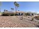 Charming single-story home with desert landscaping, palm trees, and three-car garage at 8290 Gagnier Blvd, Las Vegas, NV 89113
