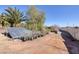 Outdoor garden area with a shade structure, potted plants, and a privacy wall at 8290 Gagnier Blvd, Las Vegas, NV 89113