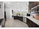 Modern kitchen featuring dark cabinetry, a kitchen island, stainless steel appliances, and ample counter space at 8290 Gagnier Blvd, Las Vegas, NV 89113