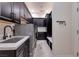 Convenient laundry room with ample storage, modern appliances, and a practical sink area at 8290 Gagnier Blvd, Las Vegas, NV 89113